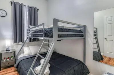 two bunk beds in a room with a bed at TWO Modern Apartment Minutes to NYC in Jersey City