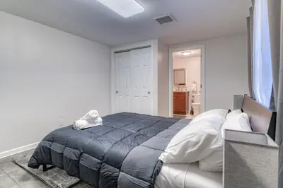 a bedroom with a bed with a blue blanket at TWO Modern Apartment Minutes to NYC in Jersey City