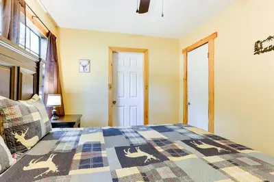 a bedroom with a bed with a quilt on it at Pools and Ski Access Lackawaxen Cottage with Deck! in Lackawaxen