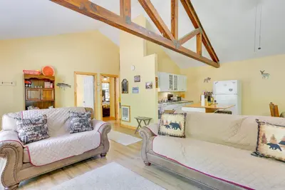 a living room with two couches and a kitchen at Pools and Ski Access Lackawaxen Cottage with Deck! in Lackawaxen