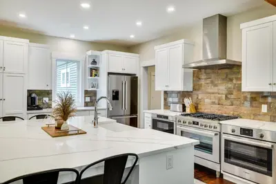 a kitchen with white cabinets and white counter tops at Cresco Countryside Oasis Surrounded by Nature! in Cresco