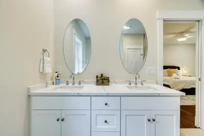 a bathroom with two sinks and two mirrors at Cresco Countryside Oasis Surrounded by Nature! in Cresco