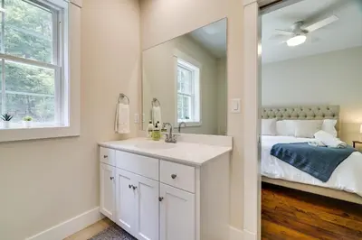 a white bathroom with a sink and a bed at Cresco Countryside Oasis Surrounded by Nature! in Cresco