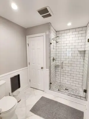 a white bathroom with a toilet and a shower at Charming 1BDR In Central Rittenhouse Square With Patio Hosted by StayRafa in Philadelphia
