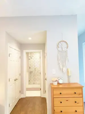 a room with a dresser and a door with a chandelier at Charming 1BDR In Central Rittenhouse Square With Patio Hosted by StayRafa in Philadelphia