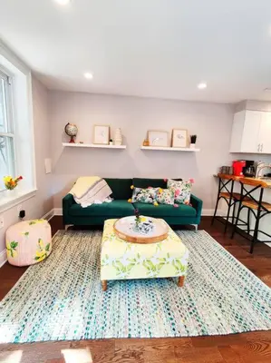 a living room with a green couch and a table at Charming 1BDR In Central Rittenhouse Square With Patio Hosted by StayRafa in Philadelphia