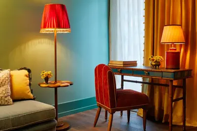 a room with a desk and a chair and a lamp at The Fifth Avenue Hotel in New York