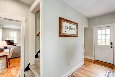 a room with a white door and a living room at Beautiful Farmhouse close to Lanc Hershey Etown in Mount Joy