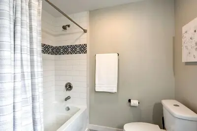 a white bathroom with a tub and a toilet at Beautiful Farmhouse close to Lanc Hershey Etown in Mount Joy