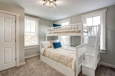 a bedroom with a white bunk bed and a staircase at Beautiful Farmhouse close to Lanc Hershey Etown in Mount Joy