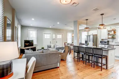 a living room with a couch and a kitchen at Beautiful Farmhouse close to Lanc Hershey Etown in Mount Joy