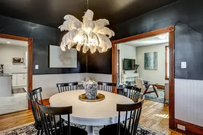 a dining room with a table and a chandelier at The Conservatory-20 min to Lanc in Mount Joy