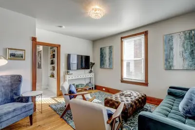 a living room with a blue couch and a fireplace at The Conservatory-20 min to Lanc in Mount Joy