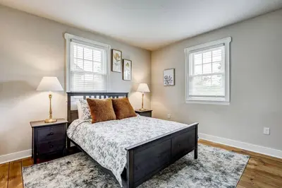 a bedroom with a bed and two windows at Victorian Manor on Main w 6 beds-10 mins to Lanc in Mountville