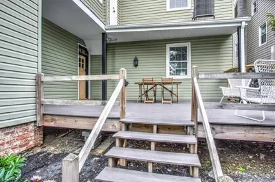 a wooden porch with stairs leading to a house at Victorian Manor on Main w 6 beds-10 mins to Lanc in Mountville