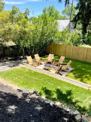 a backyard with chairs and a fire pit in the grass at Victorian Manor on Main w 6 beds-10 mins to Lanc in Mountville