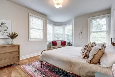 a bedroom with a large bed and windows at Victorian Manor on Main w 6 beds-10 mins to Lanc in Mountville