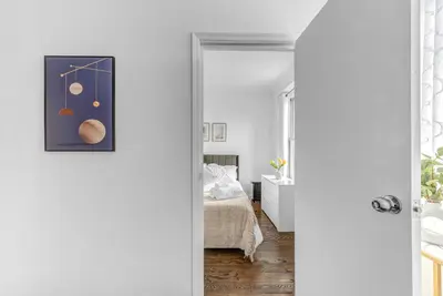 an open door into a bedroom with a bed at 2Bd Stylish Brooklyn Heights - Steps WaterFront in Brooklyn