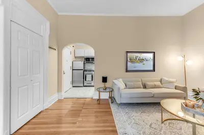 a living room with a white couch and a table at Charming 2Bd in Brooklyn Heights in Brooklyn