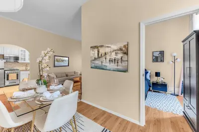 a kitchen and living room with a table and chairs at Charming 2Bd in Brooklyn Heights in Brooklyn