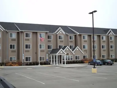 an exterior view of a large building with a parking lot at Microtel Inn & Suites Mansfield PA in Mansfield