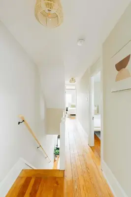 a hallway with white walls and a ceiling with a chandelier at Quaint Boho Home in Lancaster City in Lancaster