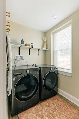 a washing machine in a laundry room with a window at Quaint Boho Home in Lancaster City in Lancaster