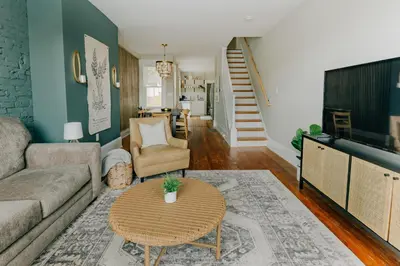 a living room with a couch and a table at Quaint Boho Home in Lancaster City in Lancaster