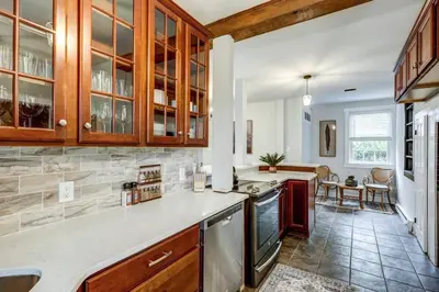 a kitchen with wooden cabinets and a counter top at Cozy Dark & Moody Home New Reno 10 mins to Lanc in Mountville