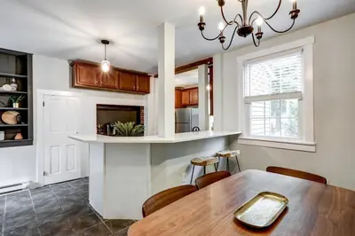 a kitchen and dining room with a table and chairs at Cozy Dark & Moody Home New Reno 10 mins to Lanc in Mountville