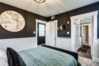 a bedroom with a bed and a map on the wall at Cozy Dark & Moody Home New Reno 10 mins to Lanc in Mountville
