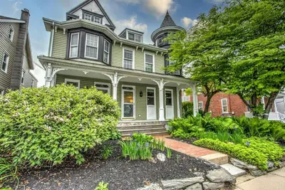 a green house with a turret on top of it at Cozy Dark & Moody Home New Reno 10 mins to Lanc in Mountville
