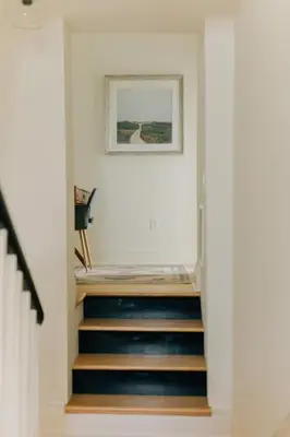 a hallway with stairs with a picture on the wall at Newly Renovated Vintage Inspired Large 4 BR Home in Mount Joy