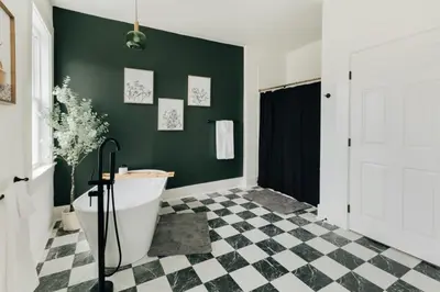 a bathroom with a bath tub and a green wall at Newly Renovated Vintage Inspired Large 4 BR Home in Mount Joy