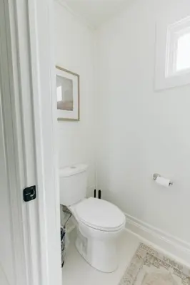 a white bathroom with a toilet in a room at Newly Renovated Vintage Inspired Large 4 BR Home in Mount Joy