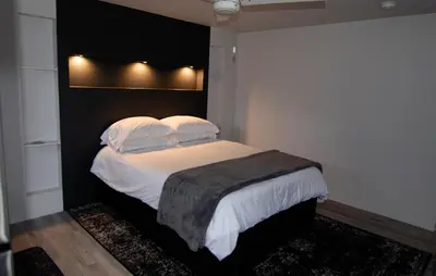 a bedroom with a bed with white sheets and pillows at Silva Domus in West Orange