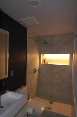 a bathroom with a shower and a toilet and a sink at Silva Domus in West Orange