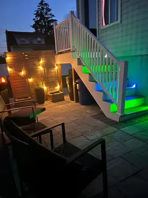 a patio with a staircase and a table and chairs at Silva Domus in West Orange