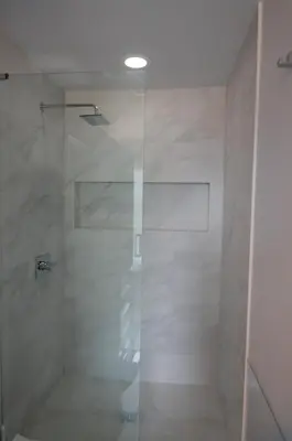 a shower with a glass door in a bathroom at Silva Domus in West Orange