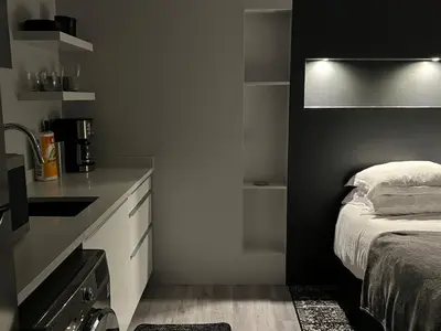a black and white bedroom with a bed and a counter at Silva Domus in West Orange