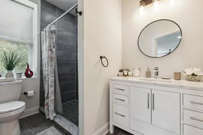 a bathroom with a toilet and a sink and a mirror at Modern City living in Philadelphia