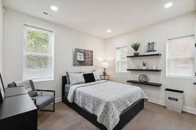 a bedroom with a bed and a chair at Modern City living in Philadelphia