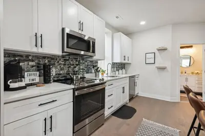 a kitchen with white cabinets and a microwave at Modern City living in Philadelphia