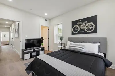 a bedroom with a large bed and a tv at Modern City living in Philadelphia