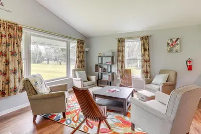 a living room with chairs and a table at Pennington Home with Deck about 9 Mi to Princeton! in Pennington