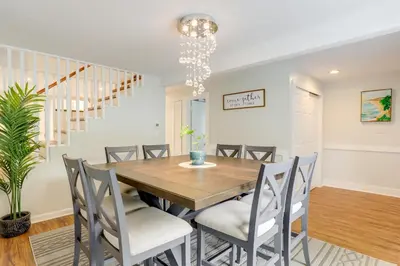 a dining room with a wooden table and chairs at Pennington Home with Deck about 9 Mi to Princeton! in Pennington