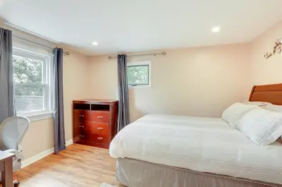 a bedroom with a bed and a dresser and a window at Pennington Home with Deck about 9 Mi to Princeton! in Pennington