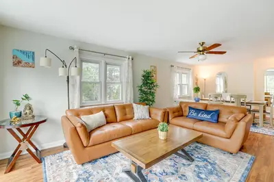 a living room with a couch and a table at Pennington Home with Deck about 9 Mi to Princeton! in Pennington