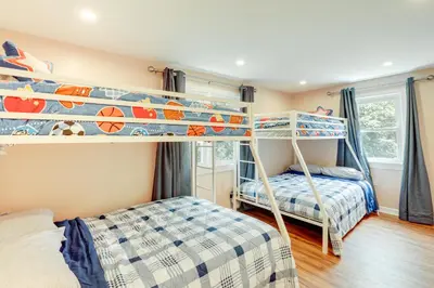 a bedroom with two bunk beds and a bed at Pennington Home with Deck about 9 Mi to Princeton! in Pennington