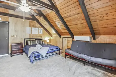 a bedroom with a bed and a couch at Poconos Chalet newly renovated, great location home in Tobyhanna